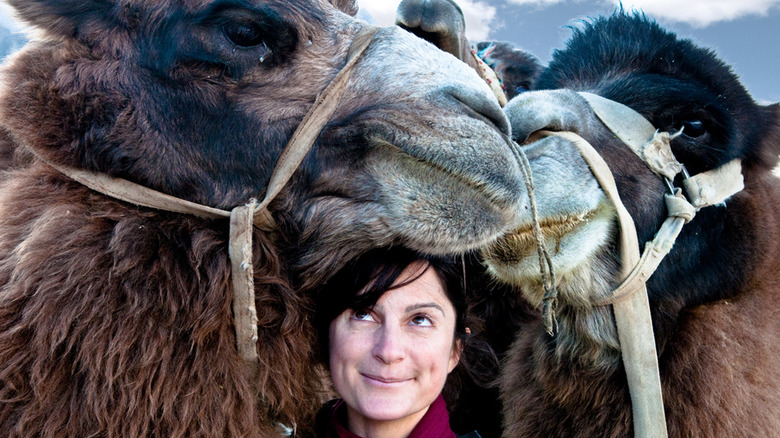 Ami Vitale posing with camels