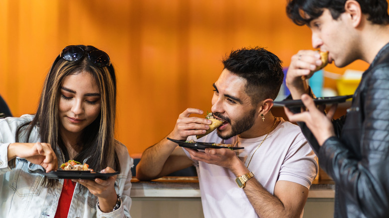 People eating tacos