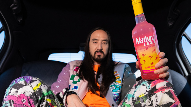 Steve Aoki holding Natural Light vodka