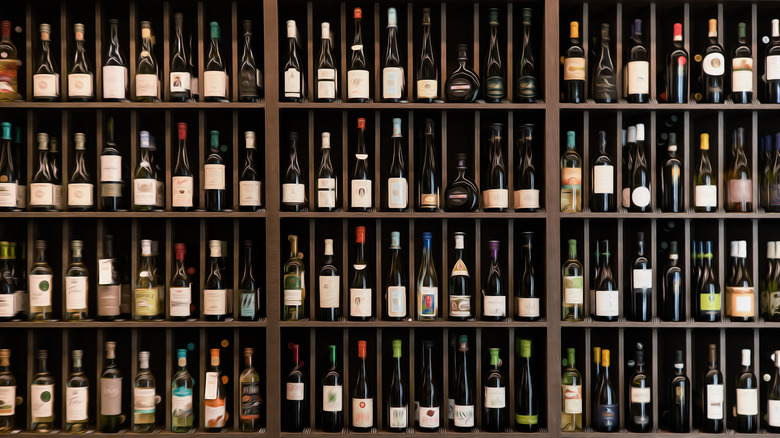 wall of wine bottles on shelves