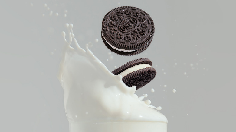 Oreos falling into a glass of milk