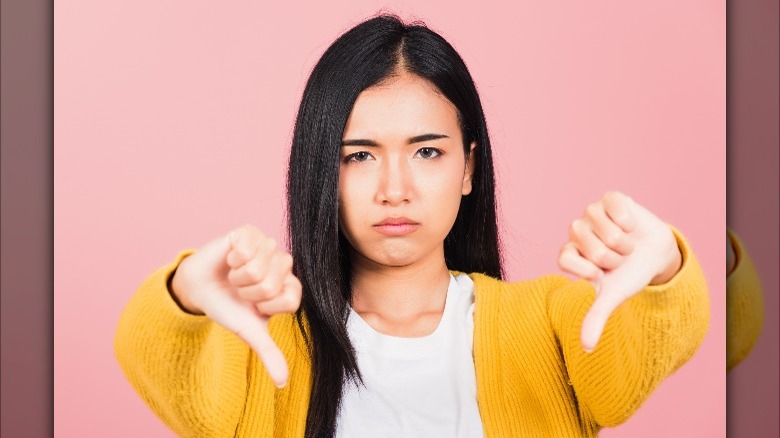 woman with thumbs down