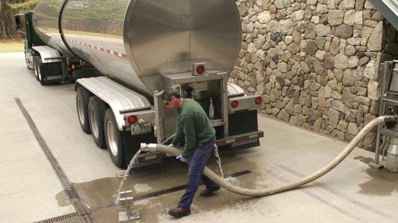 Man with truck hose collecting groundwater