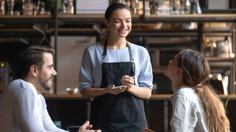 Restaurant server smiling and taking order