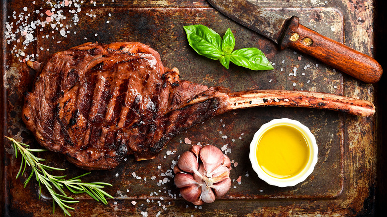 grilled steak on cutting board with seasonings