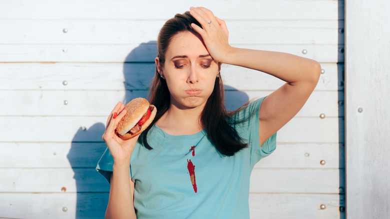 Woman with messy sandwich