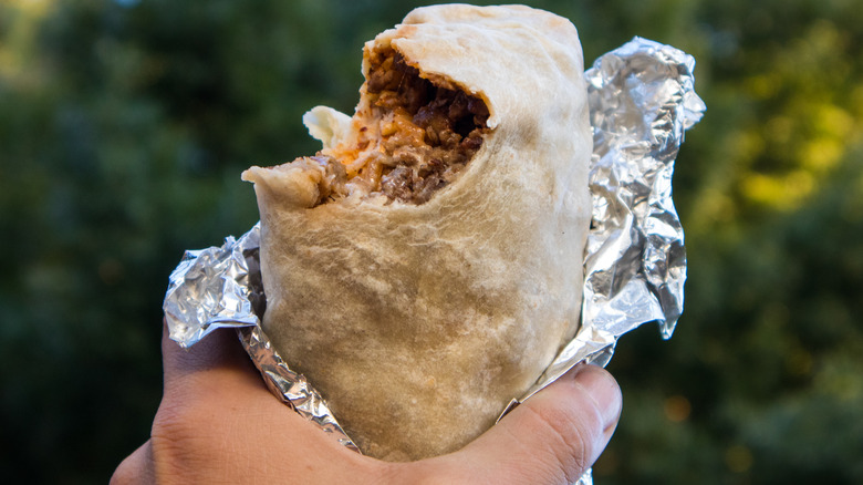 holding wrapped burrito