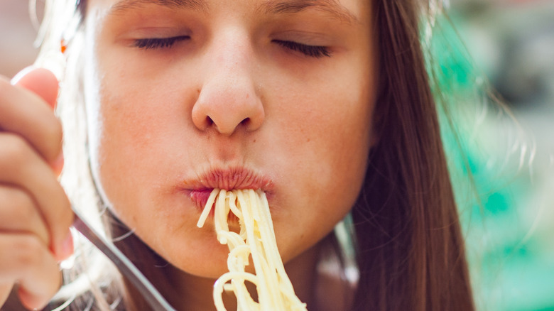 Woman eating spaghetti