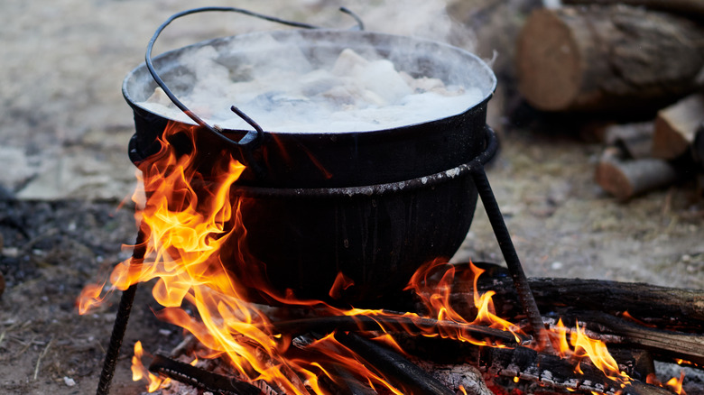 a cast iron pot over fire