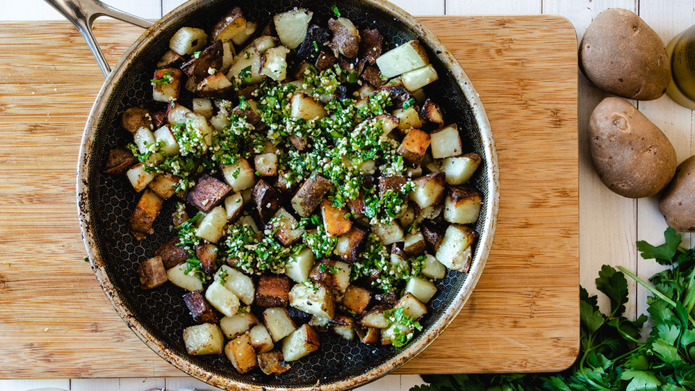 home fries with parsley and garlic in a skillet pan