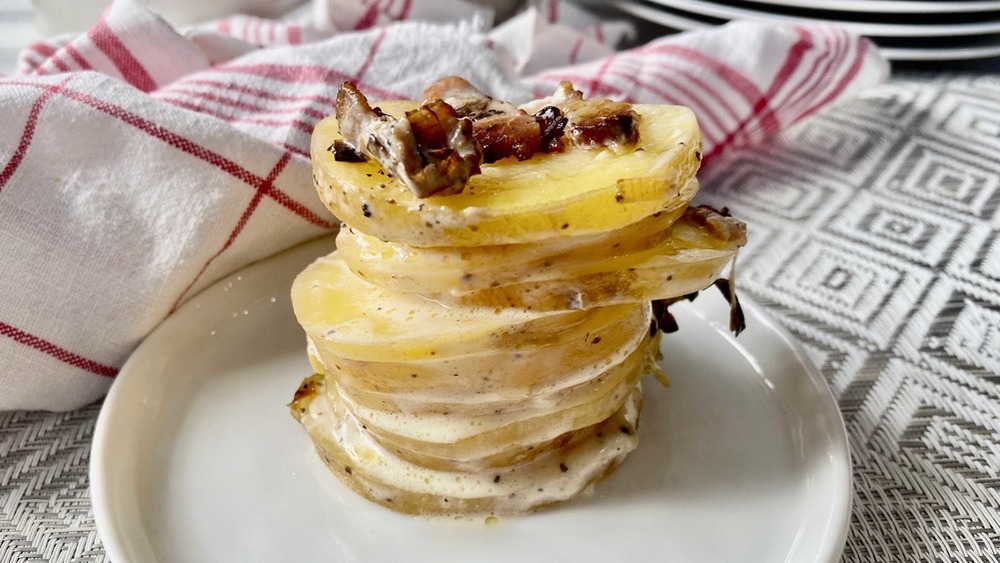 scalloped potatoes topped with bacon on a plate