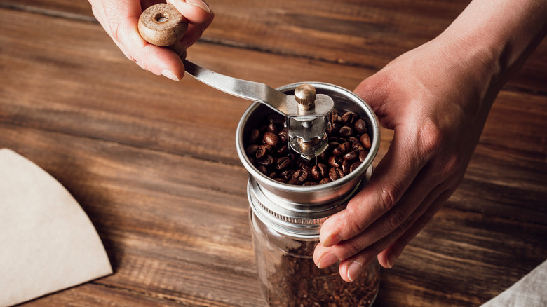 Hand-grinding coffee beans 