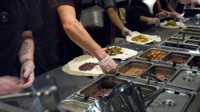 Chipotle workers making burritos