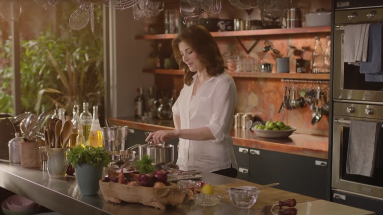 Nigella Lawson cooking in a kitchen