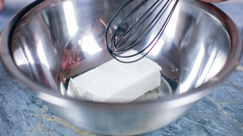 Cream cheese in a bowl for no-bake banana pudding