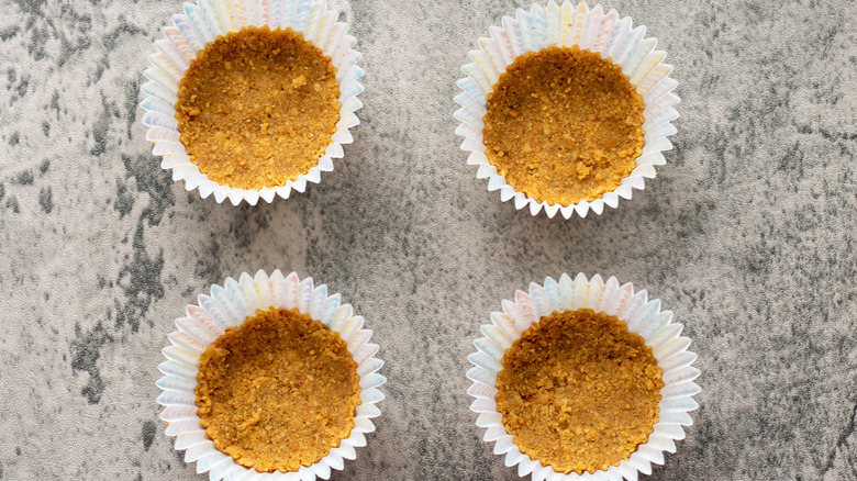 cheesecake bottom crusts in cupcake liners on counter