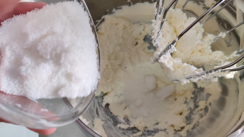 adding sugar to whipping cream in stand mixer