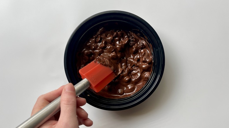 hand stirring melted chocolate