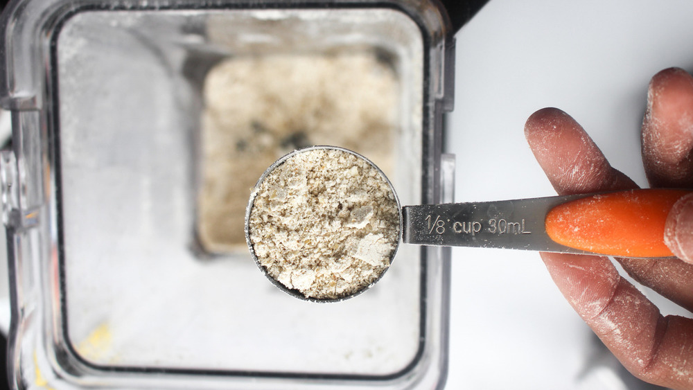 Oats being poured into a high speed blender