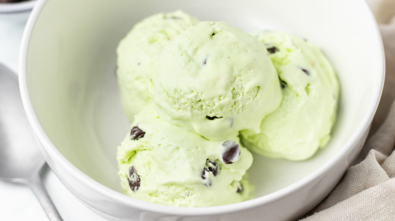 Scoops of mint chocolate chip ice cream in bowl