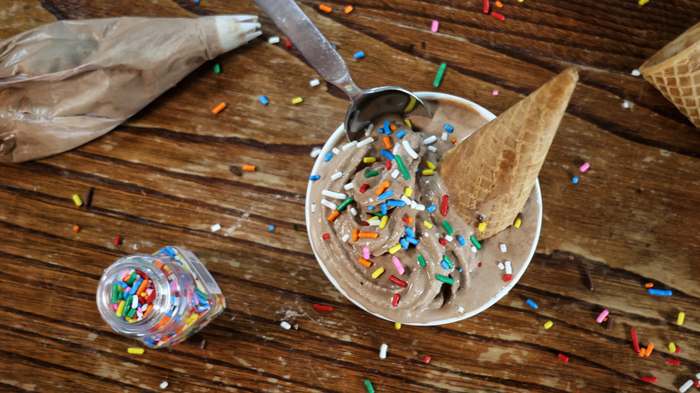 bowl of chocolate soft serve with cone and sprinkles