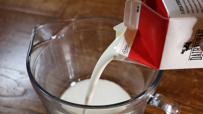 pouring cream into mixing bowl