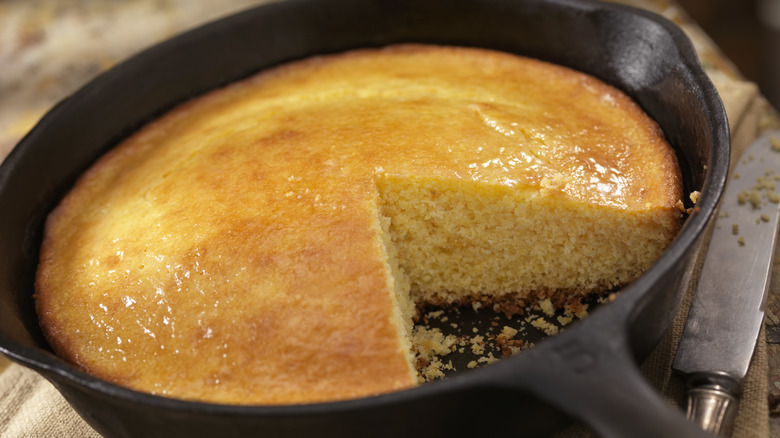 cornbread in cast iron skillet with knife