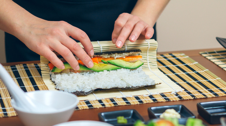 Person rolling sushi