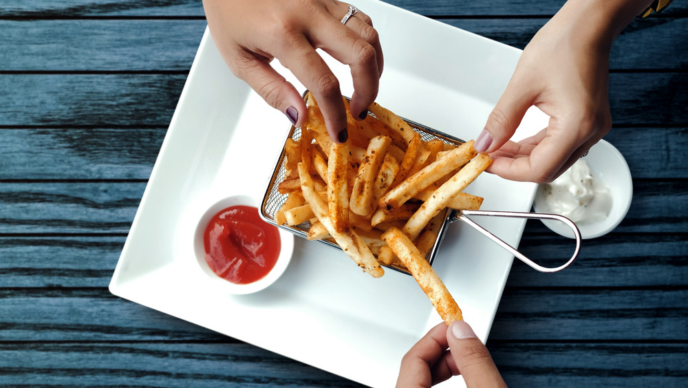 People dipping fries