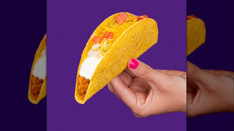 Hand holding Taco Bell taco