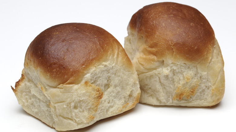 Two dinner rolls on white background