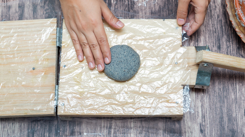 Person pressing tortillas