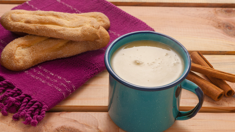 mug of atole with sweet bread