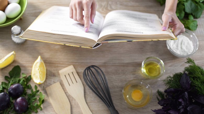 person looking at a cookbook