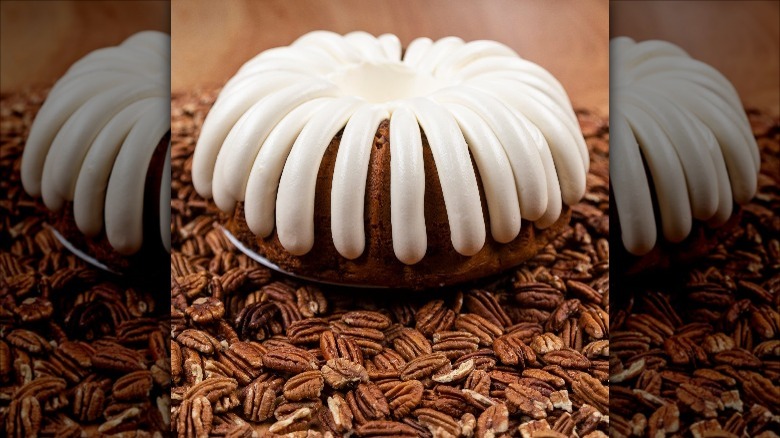 pecan praline bundt cake atop pecans