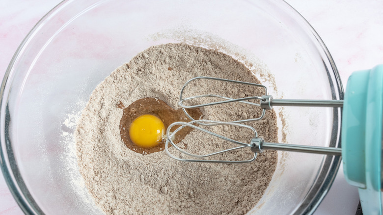 mixing an egg into dry ingredients