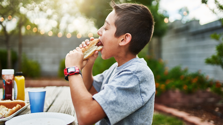 Child eating hot dog