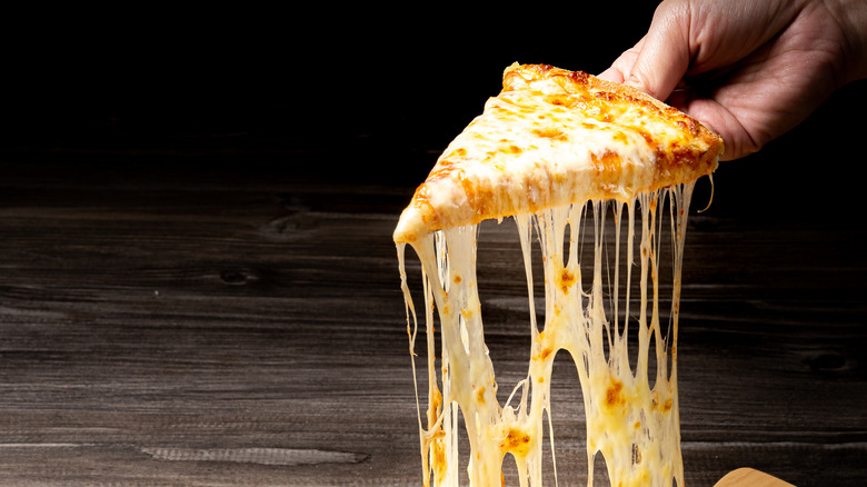 Person pulling pizza slice