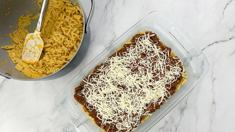 mozzarella cheese on top of mac and cheese and beef sauce