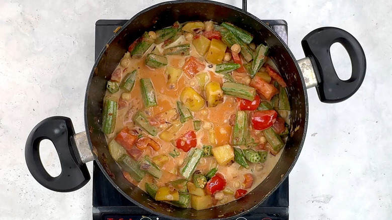 cooking okra, chickpea, potato coconut curry