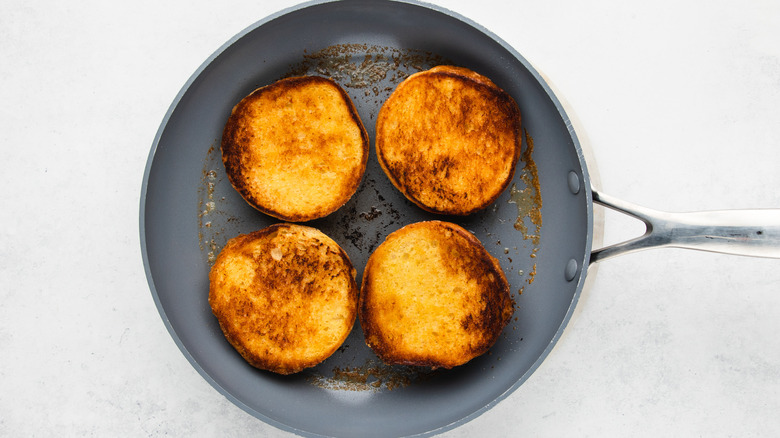 Toasted brioche buns in frying pan