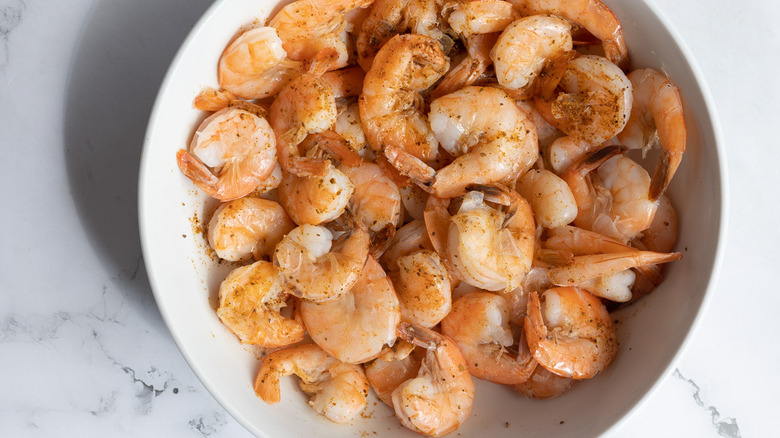 shrimp in bowl with additional seasoning