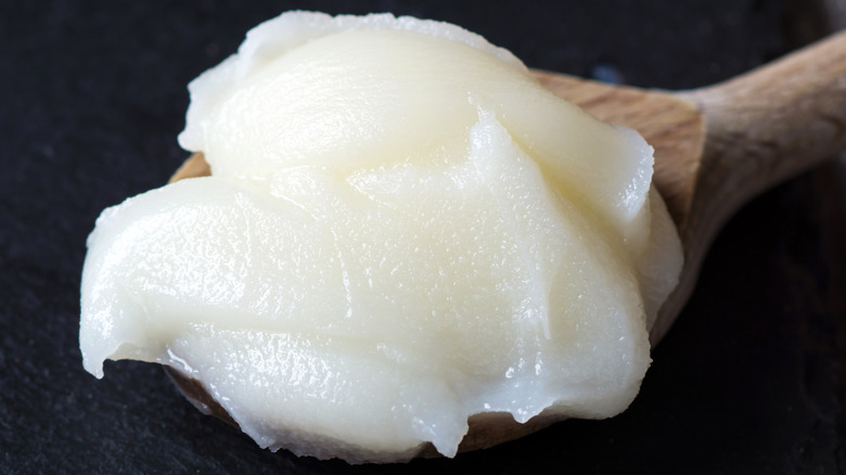 lard on wooden spoon