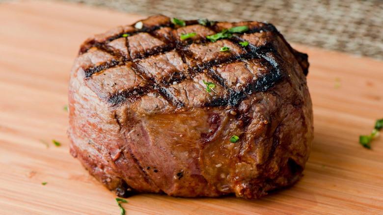 grilled filet mignon on wooden board