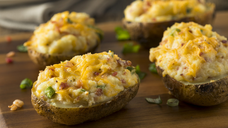 loaded twice-baked potatoes on wooden board