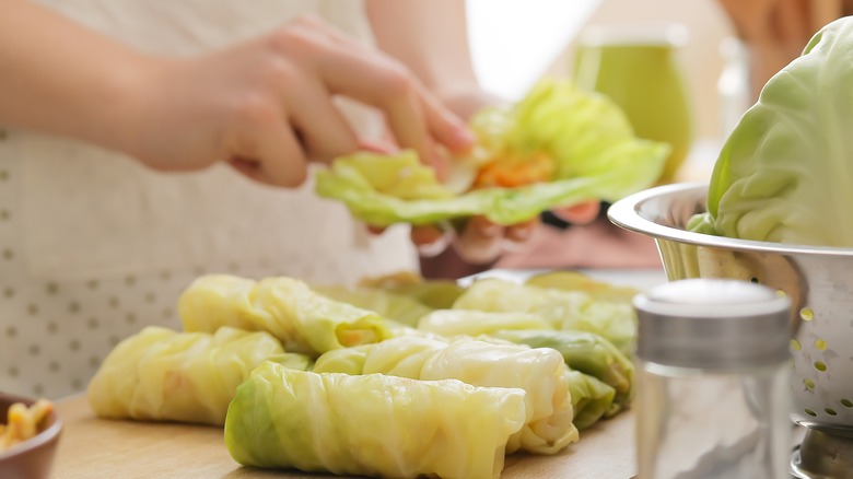 person making cabbage rolls