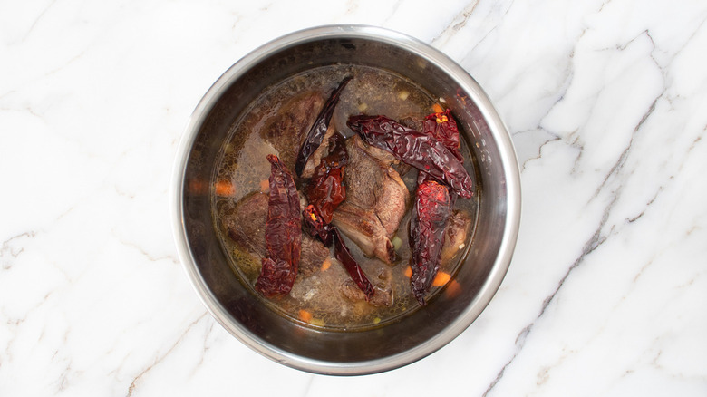 birria ingredients in metal pot