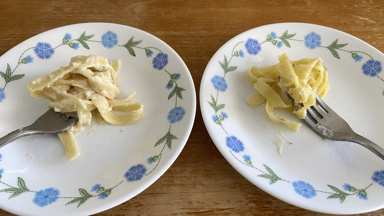 forks with pasta on plates