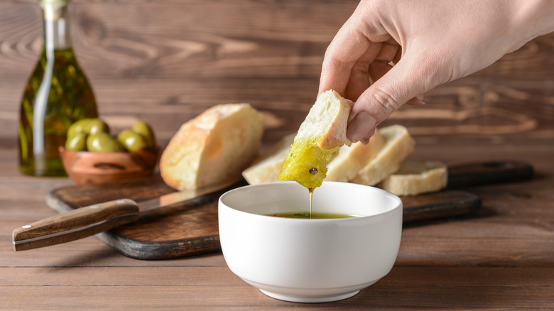 bread being dipped in olive oil