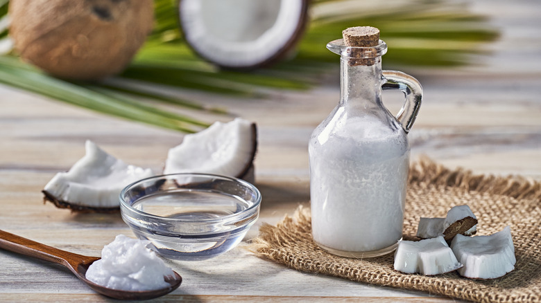 pieces of fresh coconut and coconut oil in jar